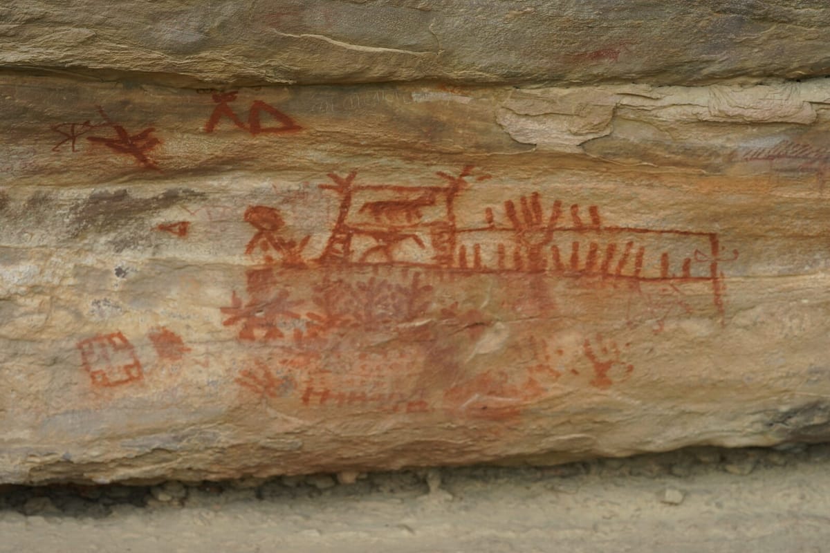 ochre figures on the shelter wall